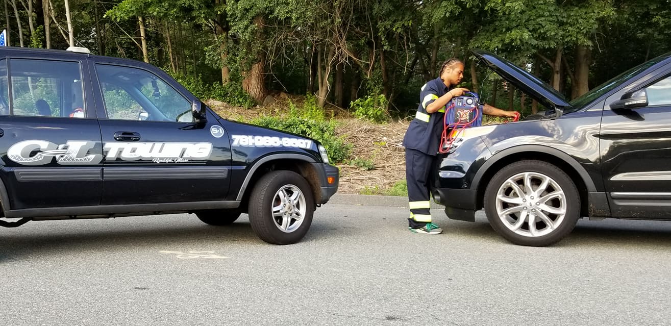 Technician Boosting a Vehicle